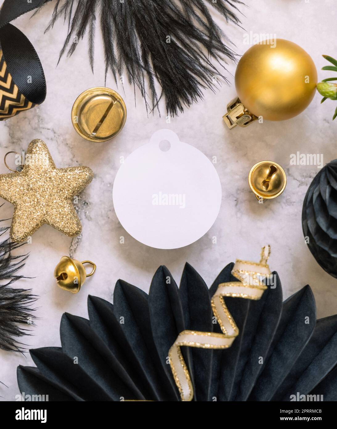 Blank round gift tag between black and golden Christmas decorations ...
