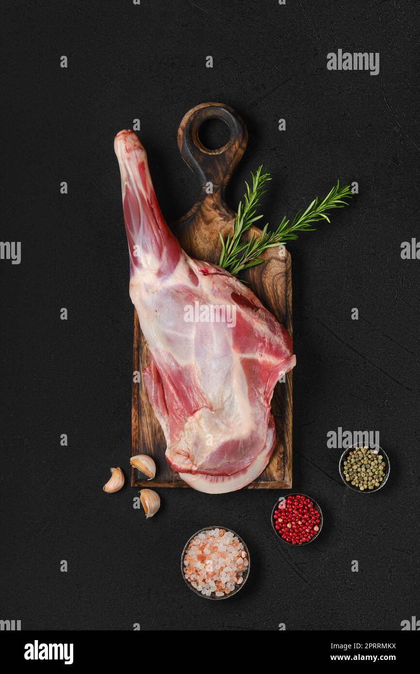 Overhead view of raw lamb short cut leg, sirloin off on wooden cut log