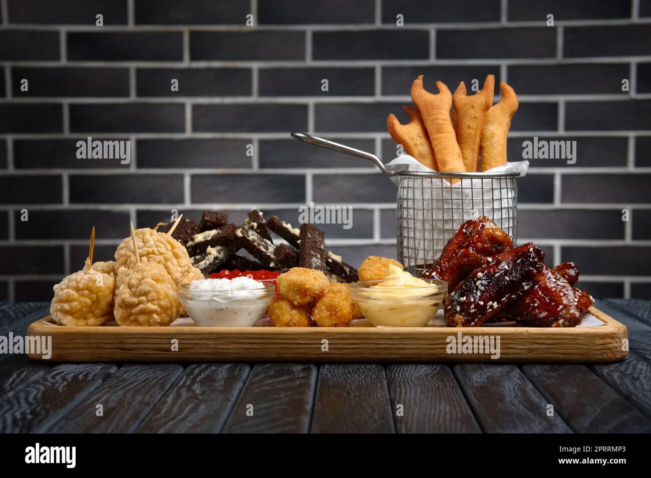 Large plate with a wide selection of snacks for beer in bar. Stock Photo