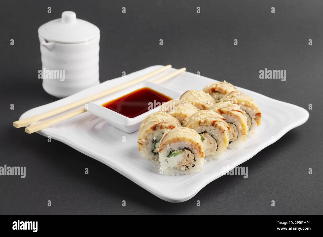 chicken teriyaki roll with chopsticks and soy sauce Stock Photo