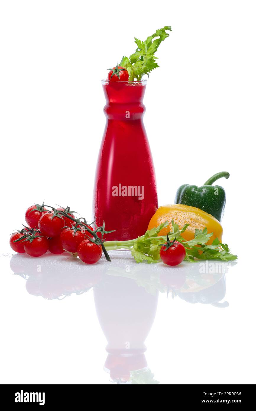 Cold drink with tomato, paprika and celery in jar with water drops