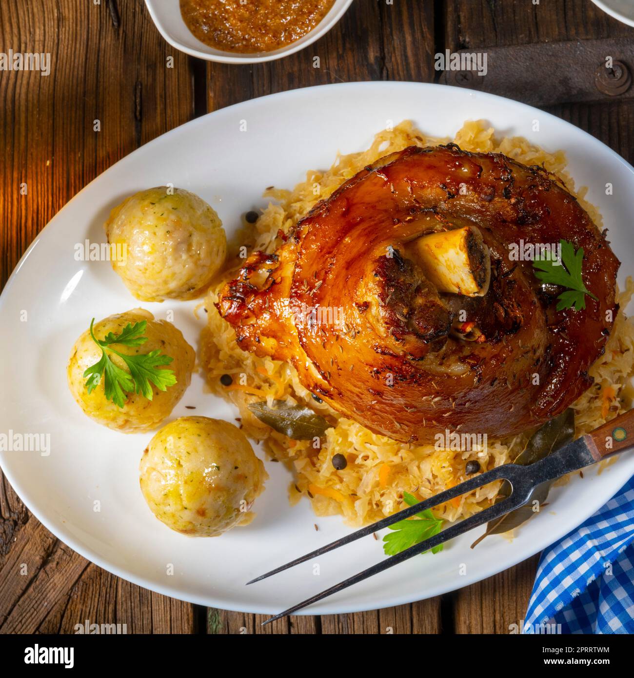 pork knuckle with sauerkraut and sweet mustard Stock Photo Alamy
