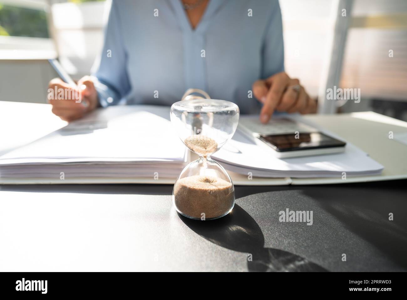 Late Invoice And Billing Deadline With Hourglass Stock Photo