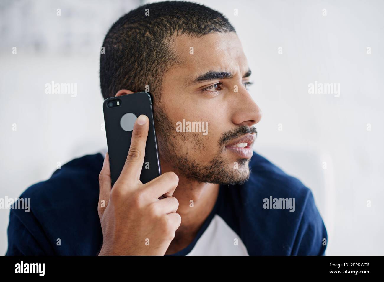 He takes your needs seriously. a handsome businessman in his office. Stock Photo