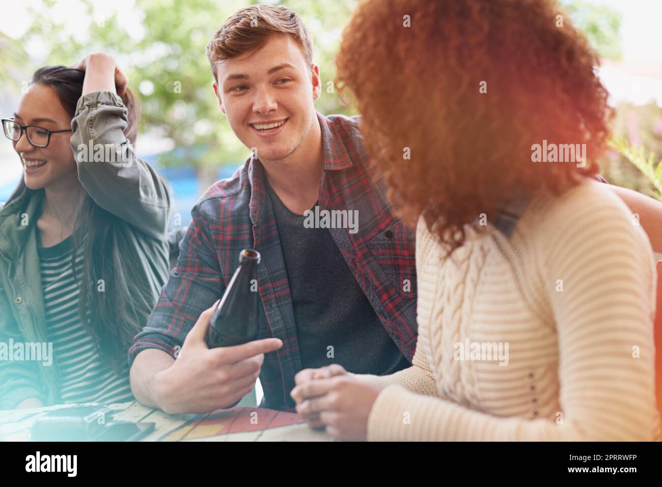 Never know when you might meet the one...a group of friends drinking outdoors. Stock Photo