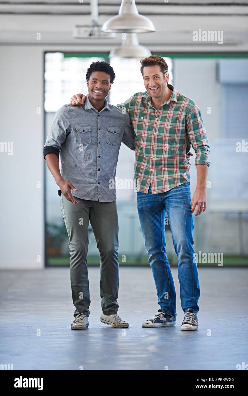 Diverse minds for strong bonds. Two handsome men standing arm in arm smiling at the camera. Stock Photo