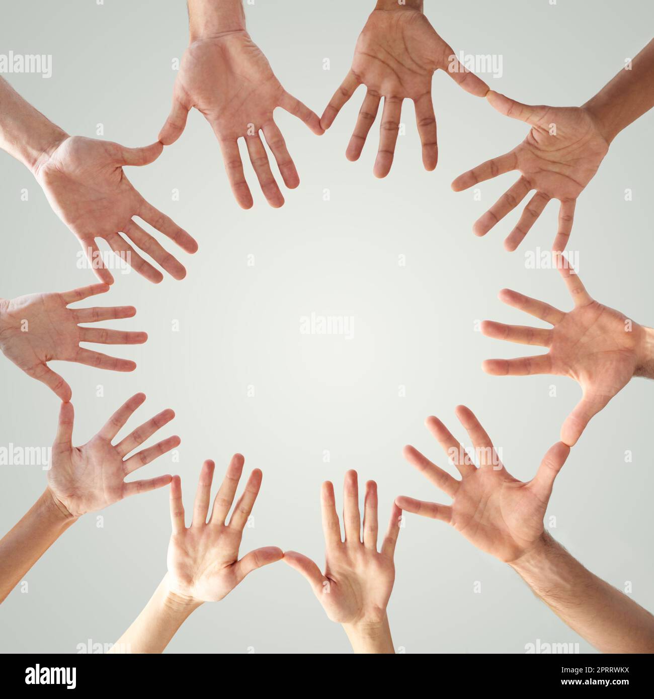 United we stand. Low angle shot of hands in a circle forming a circle. Stock Photo