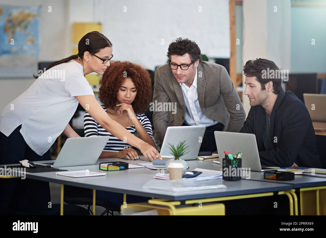 Theyre innovators in the biz. designers talking together over laptops in an office. Stock Photo