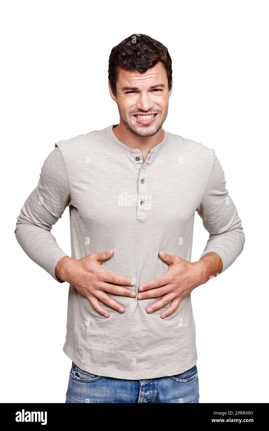 I need something to stop the pain. A young man rubbing his stomach and