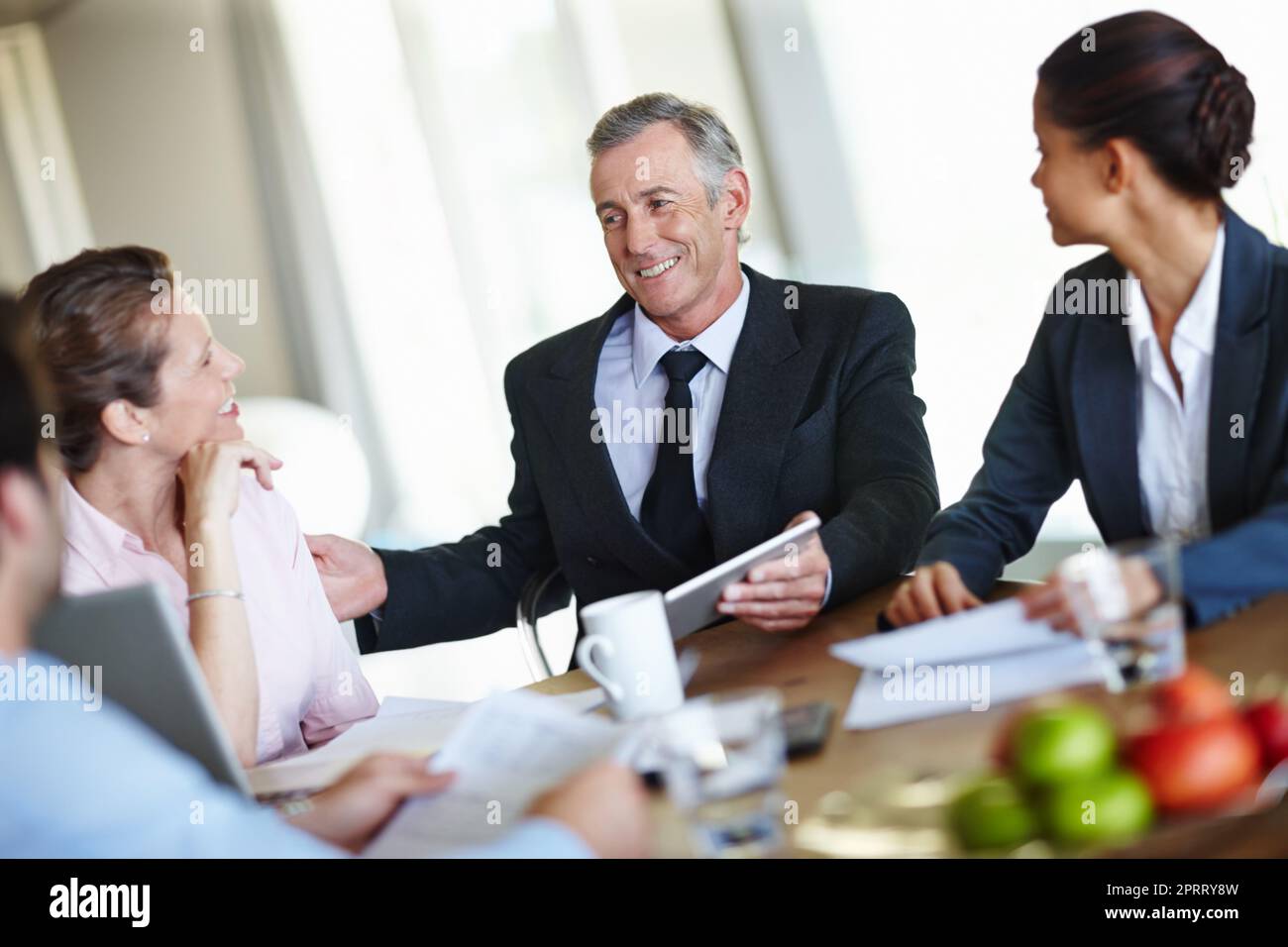 I think weve reached a solution...A group of businesspeople having a meeting and discussing business. Stock Photo