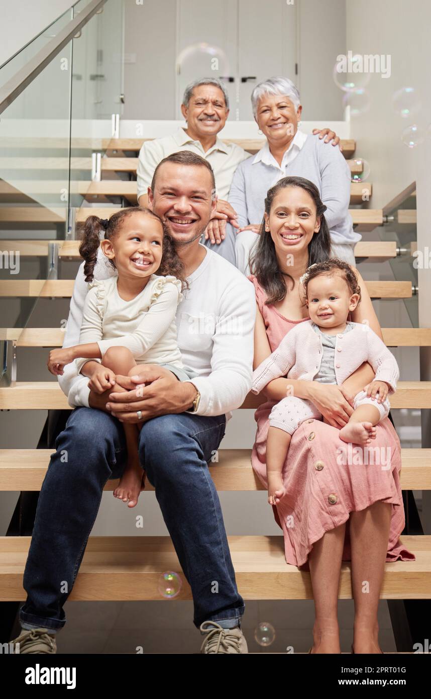 Kids portrait, happy family and parents with grandparents on stairs, smile at birthday celebration and love in house together. Elderly grandmother and man with children on steps to celebrate holiday Stock Photo