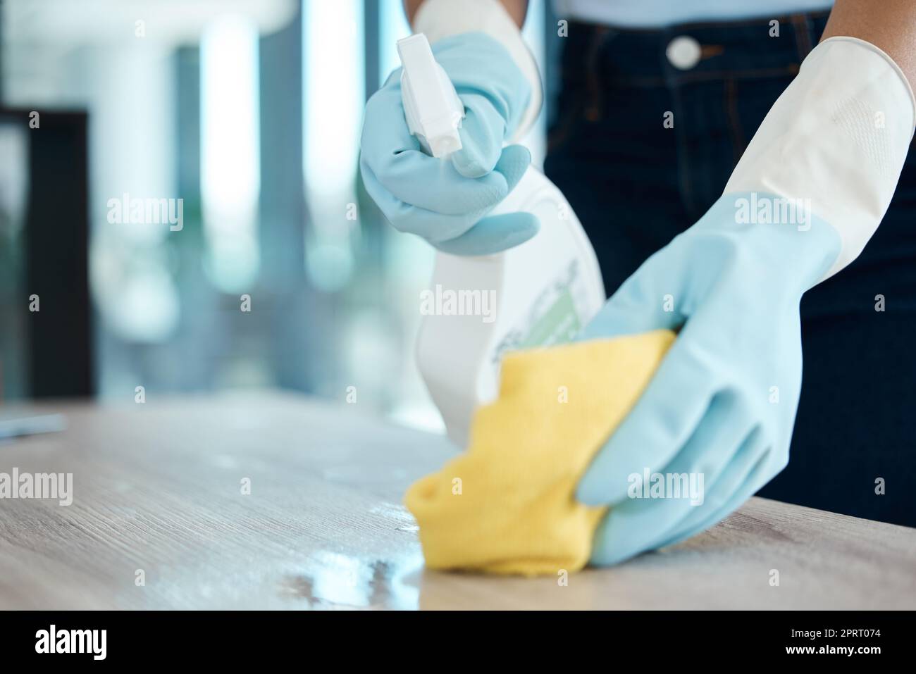 Cleaning, spray bottle and hygiene with woman with gloves for