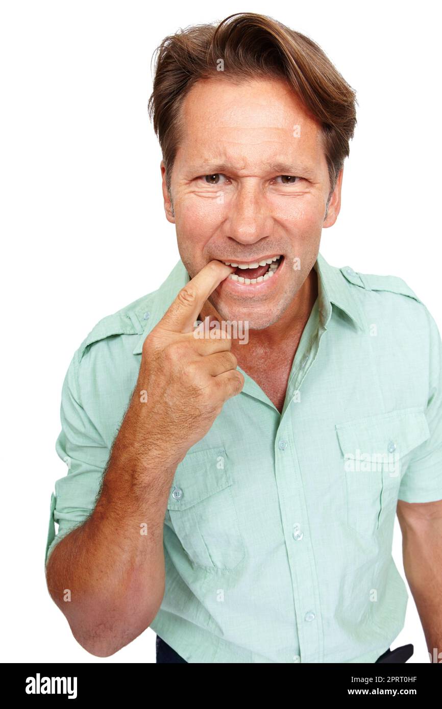I cant seem to remember....An isolated portrait of an unhappy mid adult man biting his finger. Stock Photo
