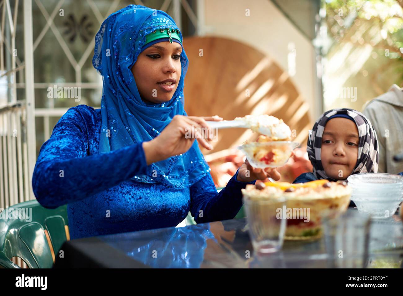 Theres always room for dessert. a muslim family eating together. Stock Photo