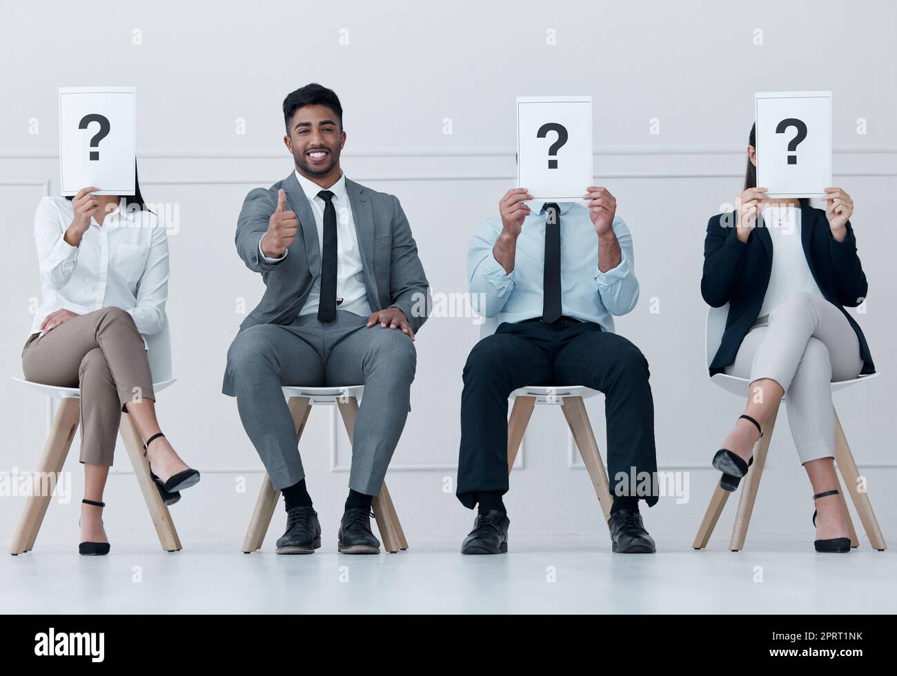 Recruitment row, question people and success of candidate with thumbs up for job interview at workplace. Happy, ok and yes hands gesture with hr proposal for onboarding of man at company. Stock Photo