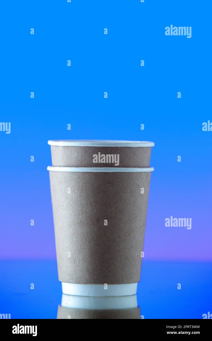 front view stuck up paper water cups on blue background Stock Photo - Alamy