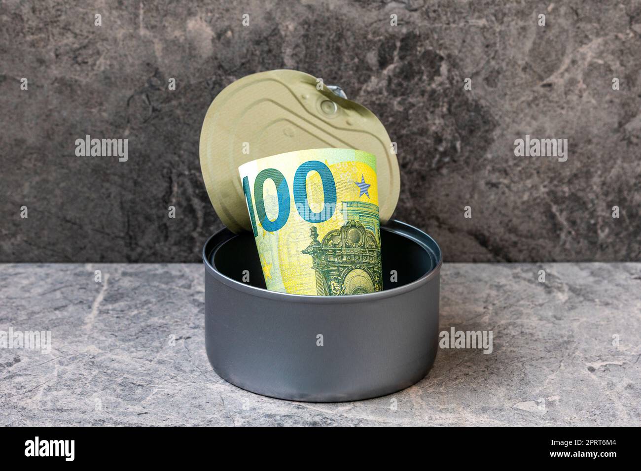 Open tin can with a one hundred Euro banknote. Financial concept image