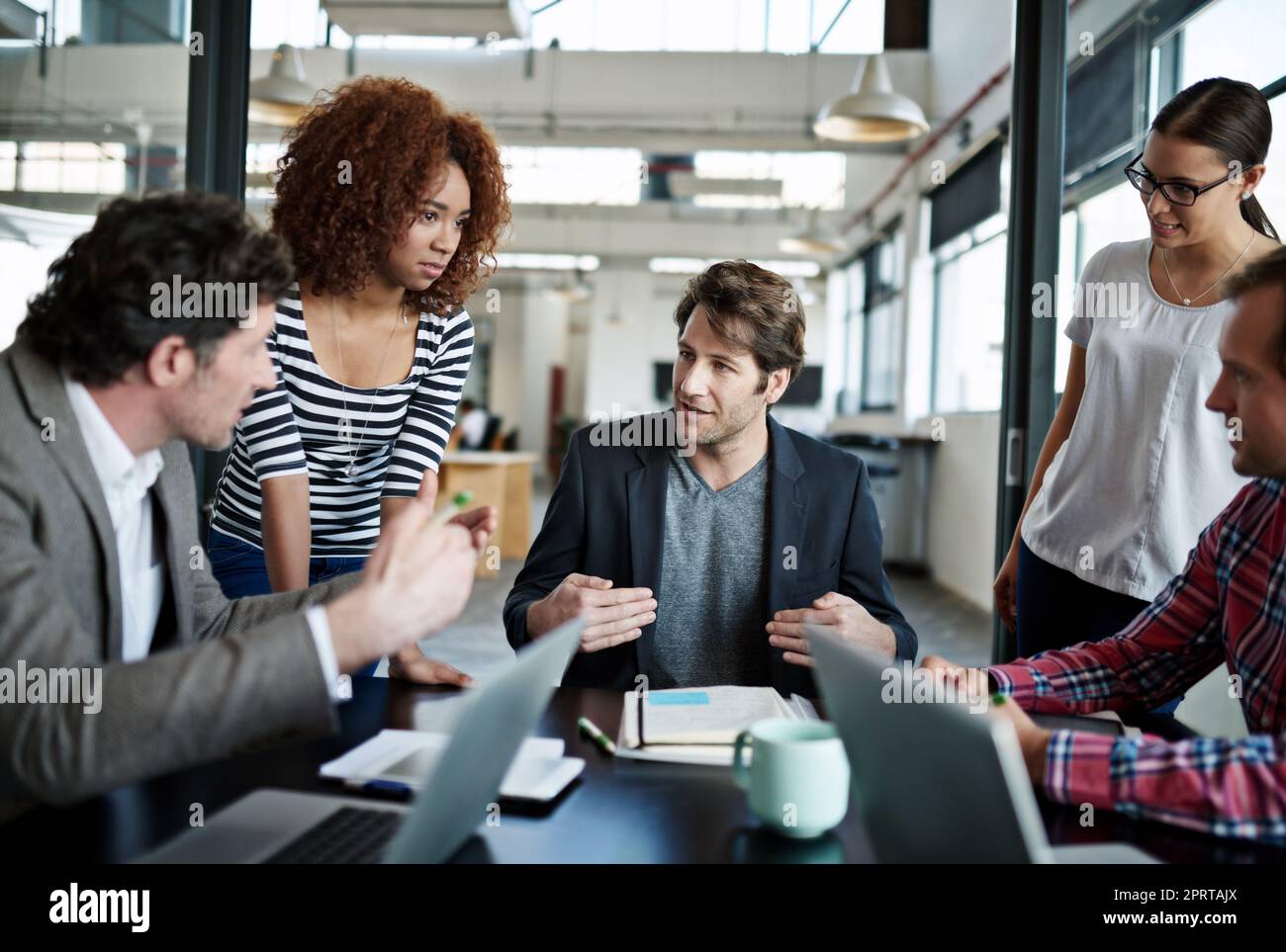 Getting a head start on the project. office workers talking in a meeting in an office. Stock Photo