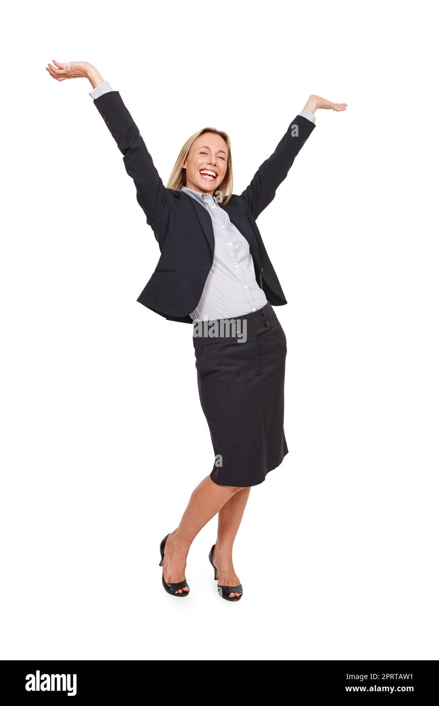 Celebrating her success. Studio portrait of an excited businesswoman standing with her arms outstretched against a white background. Stock Photo