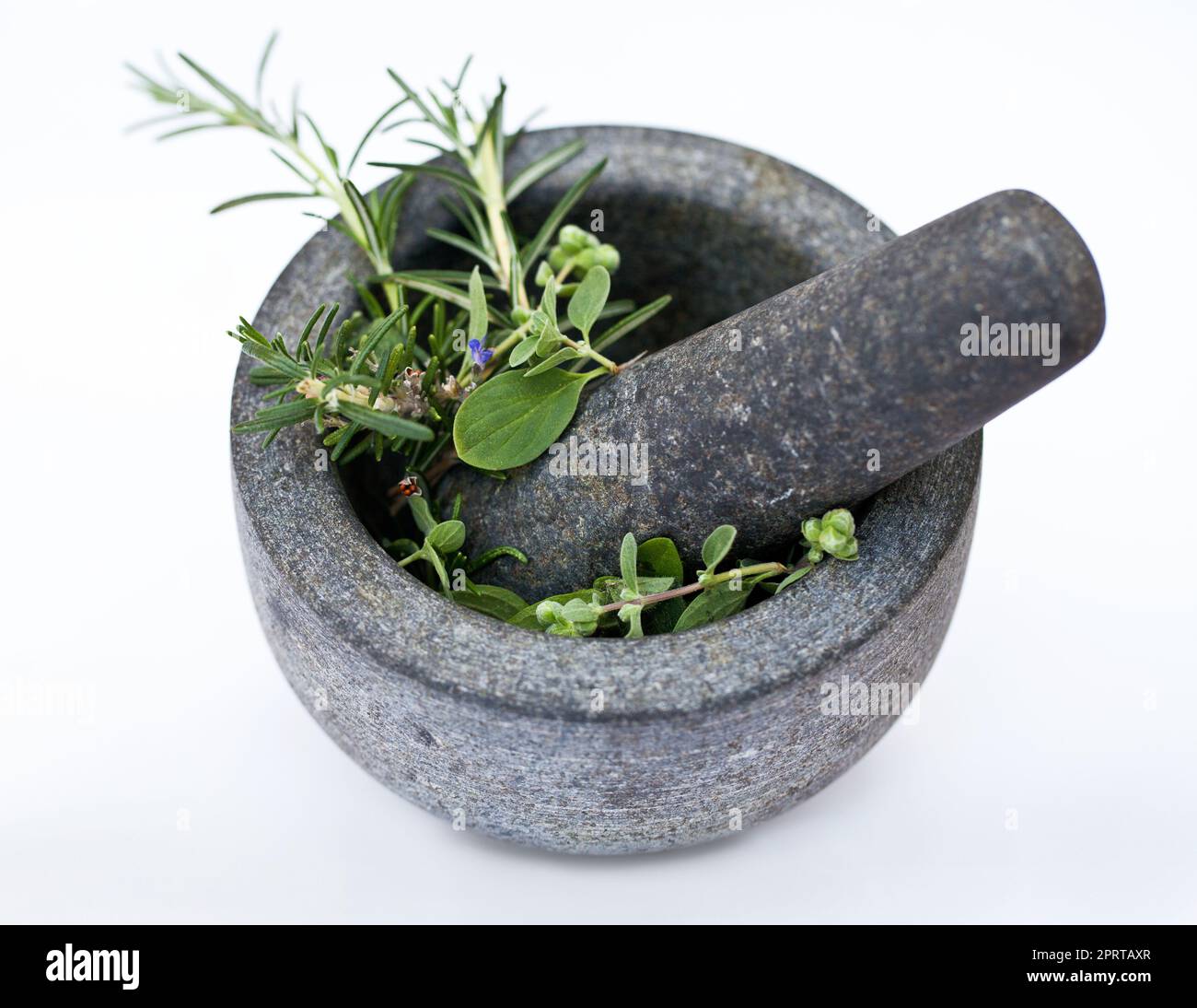 Things are going to get tasty. a mortar and pestle with herbs. Stock Photo
