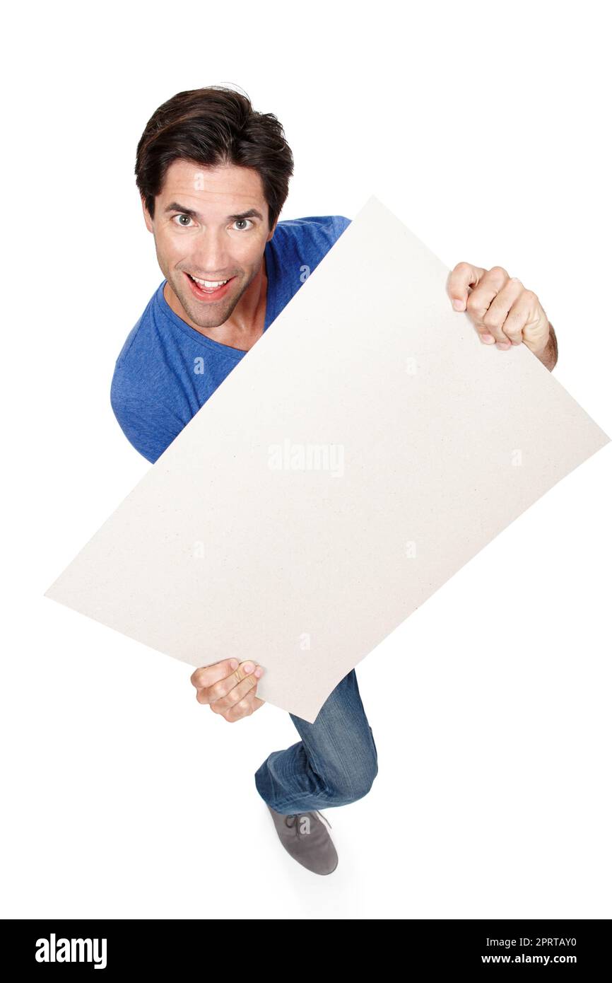 Hes enthusiastic about this. High angle studio portrait of a handsome young man holding a blank sign. Stock Photo