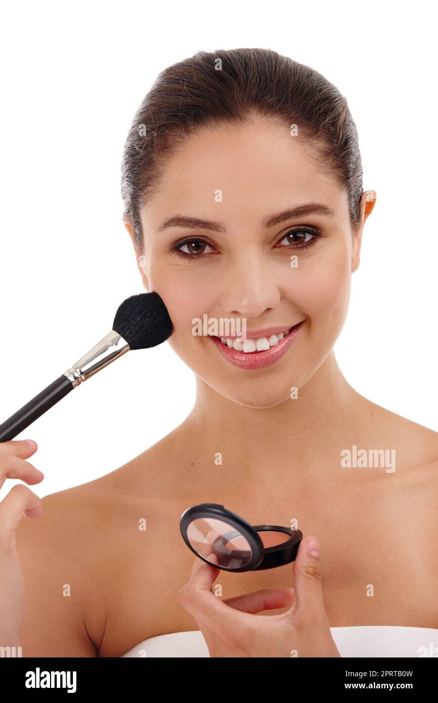 Confidence, wear it like make-up. Portrait of a beautiful young woman applying blush to her face. Stock Photo