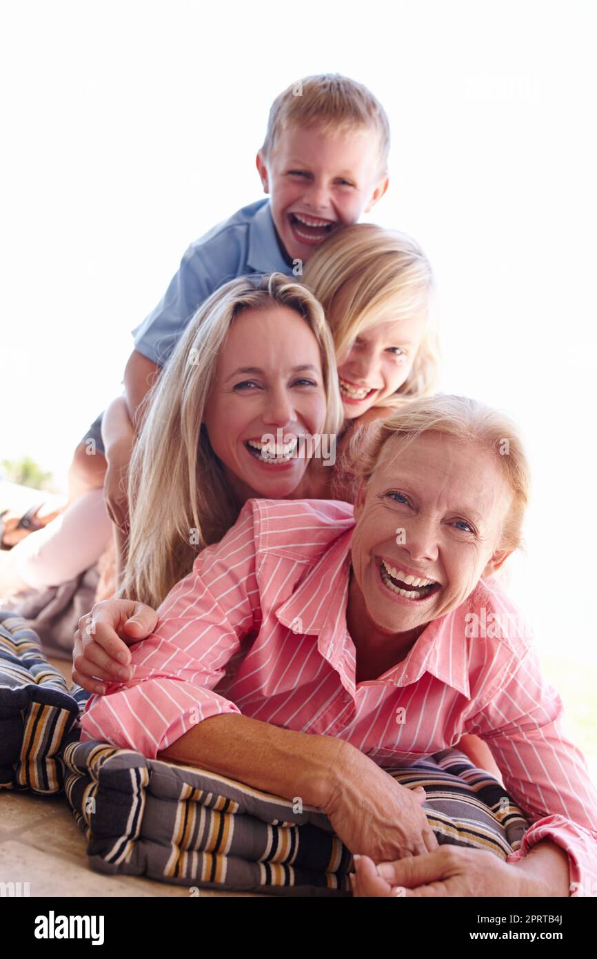 Pure joy. Portrait of an attractive woman spending time with her children and her senior mother. Stock Photo
