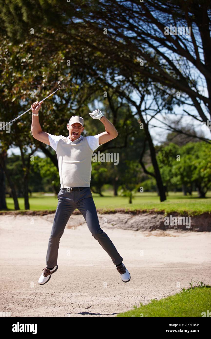 Perfect shot. a happy mature man playing a game of golf Stock Photo - Alamy