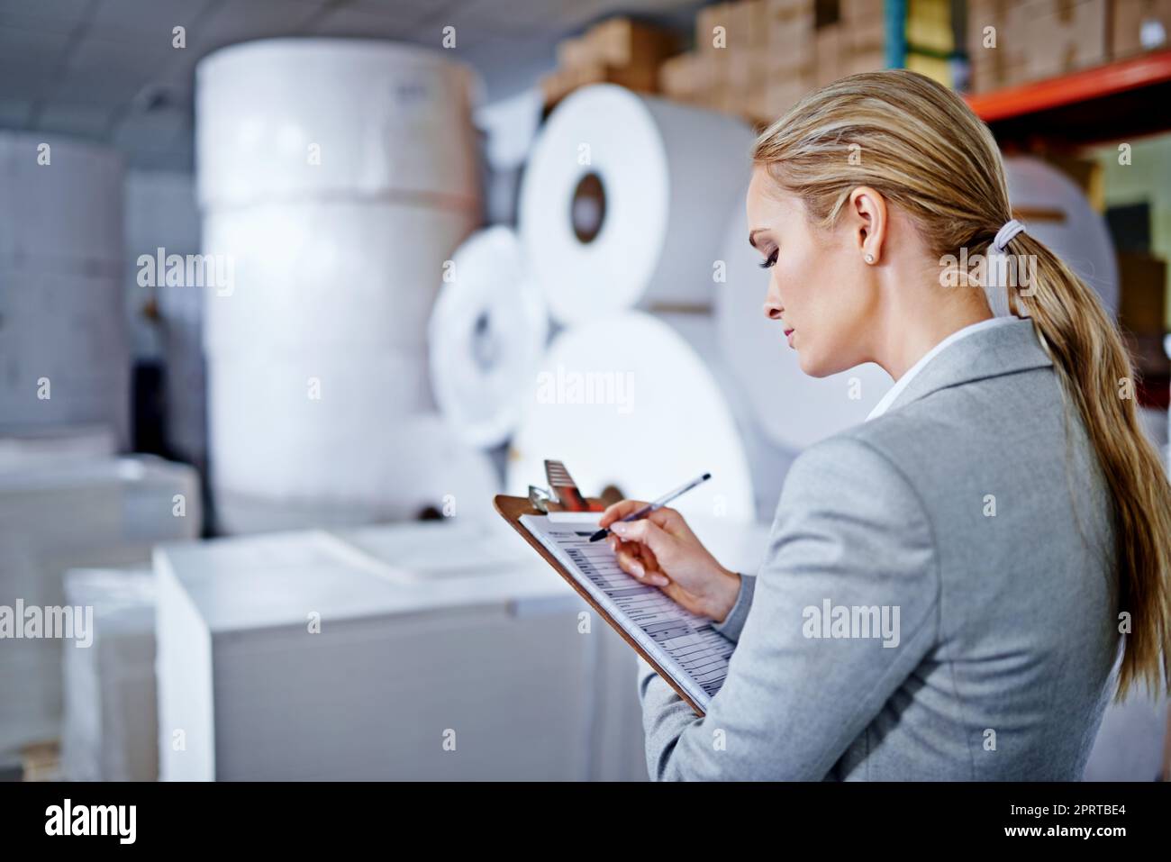 Making sure the order is perfect. a woman at work in a storage warehouse. Stock Photo