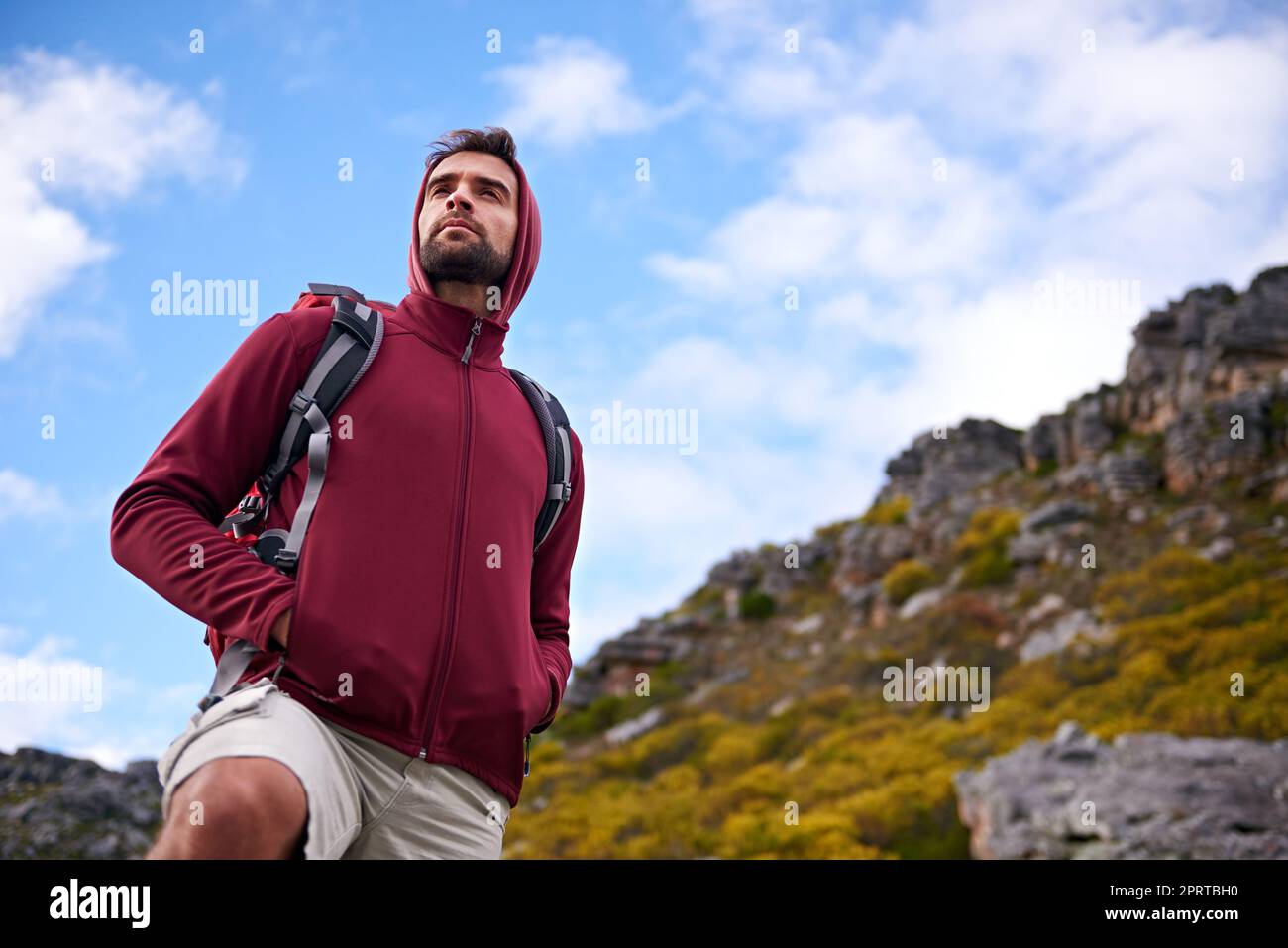 Happy man walking on trail on a hiking trip in the mountains stock photo