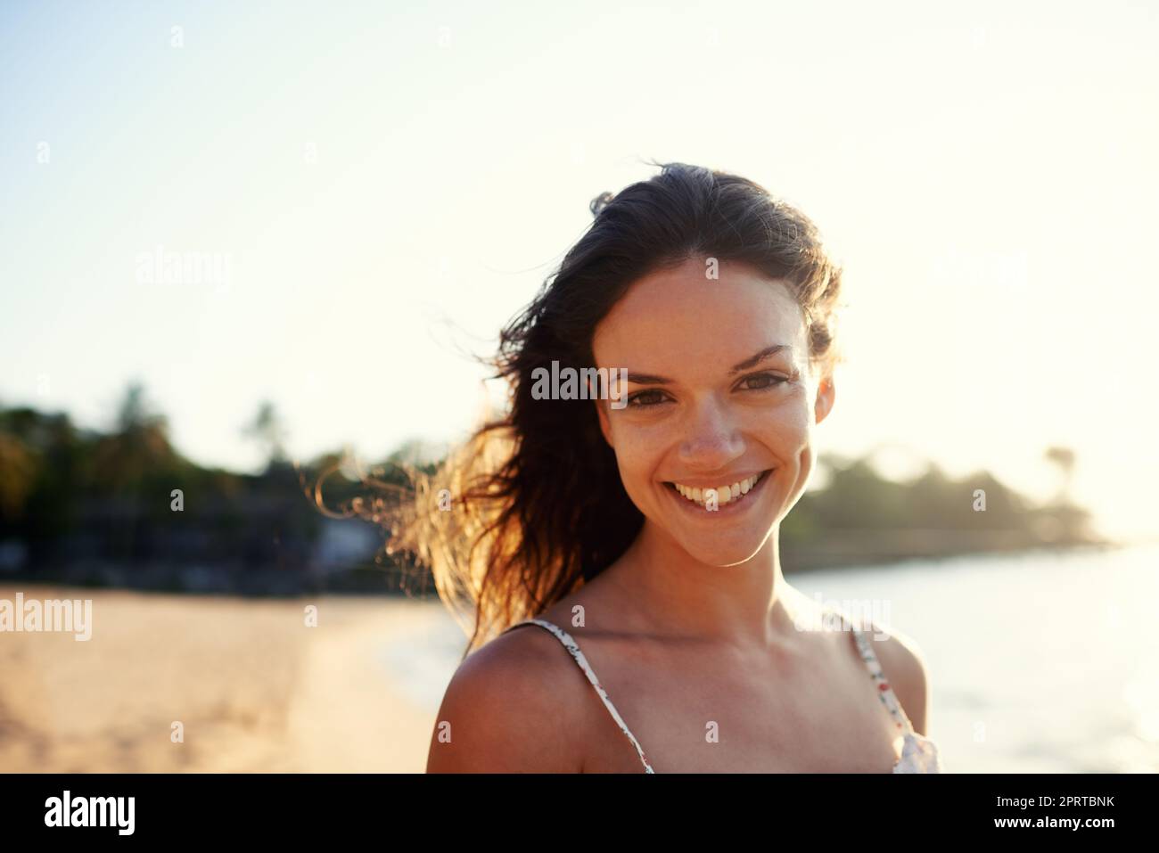 My happy place. Portrait of a beautiful young woman on the beach. Stock Photo