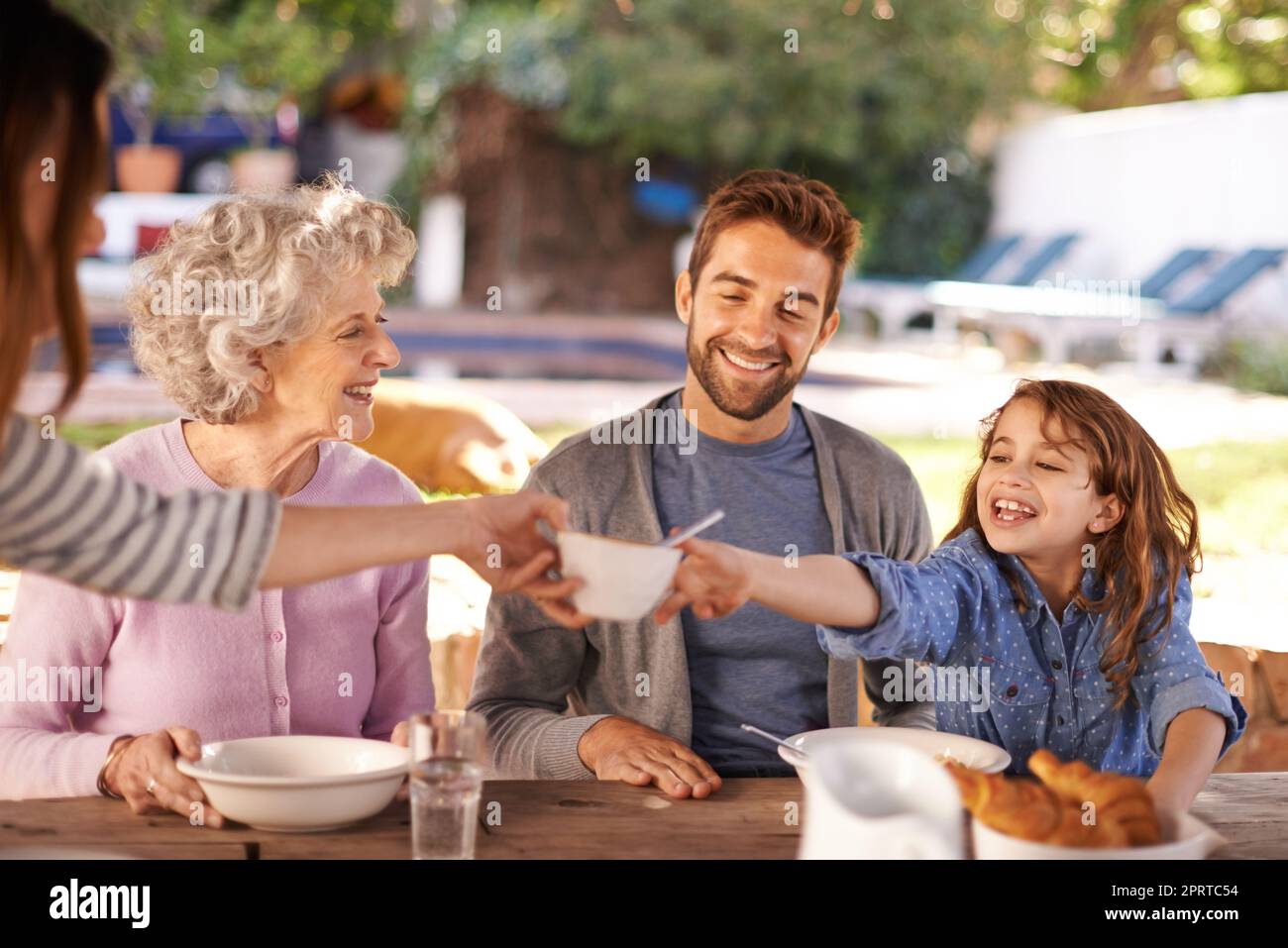 Sharing a scrumptious meal. a family having breakfast together outside. Stock Photo