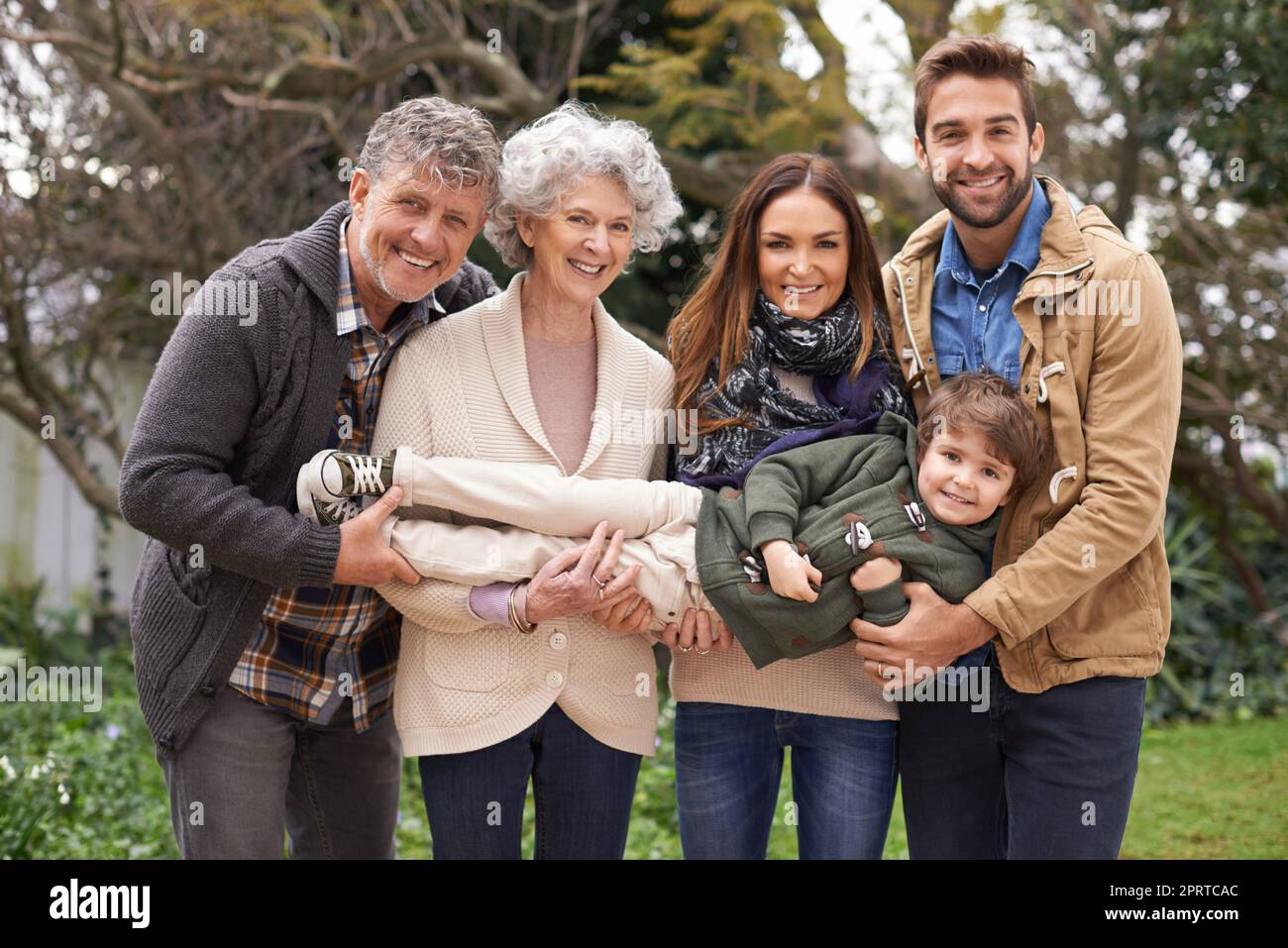 Hes all the joy we need. A multi-generation family standing outdoors. Stock Photo