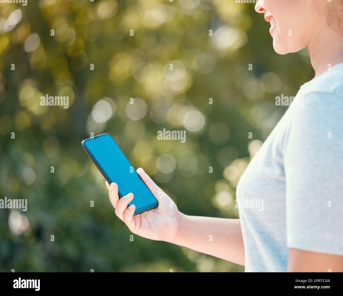 Nature walk for woman with mockup phone for peace of mind, healthy mindset or freedom with blue screen chroma key. Girl with smartphone copy space walking in outdoor park for wellness or exercise Stock Photo
