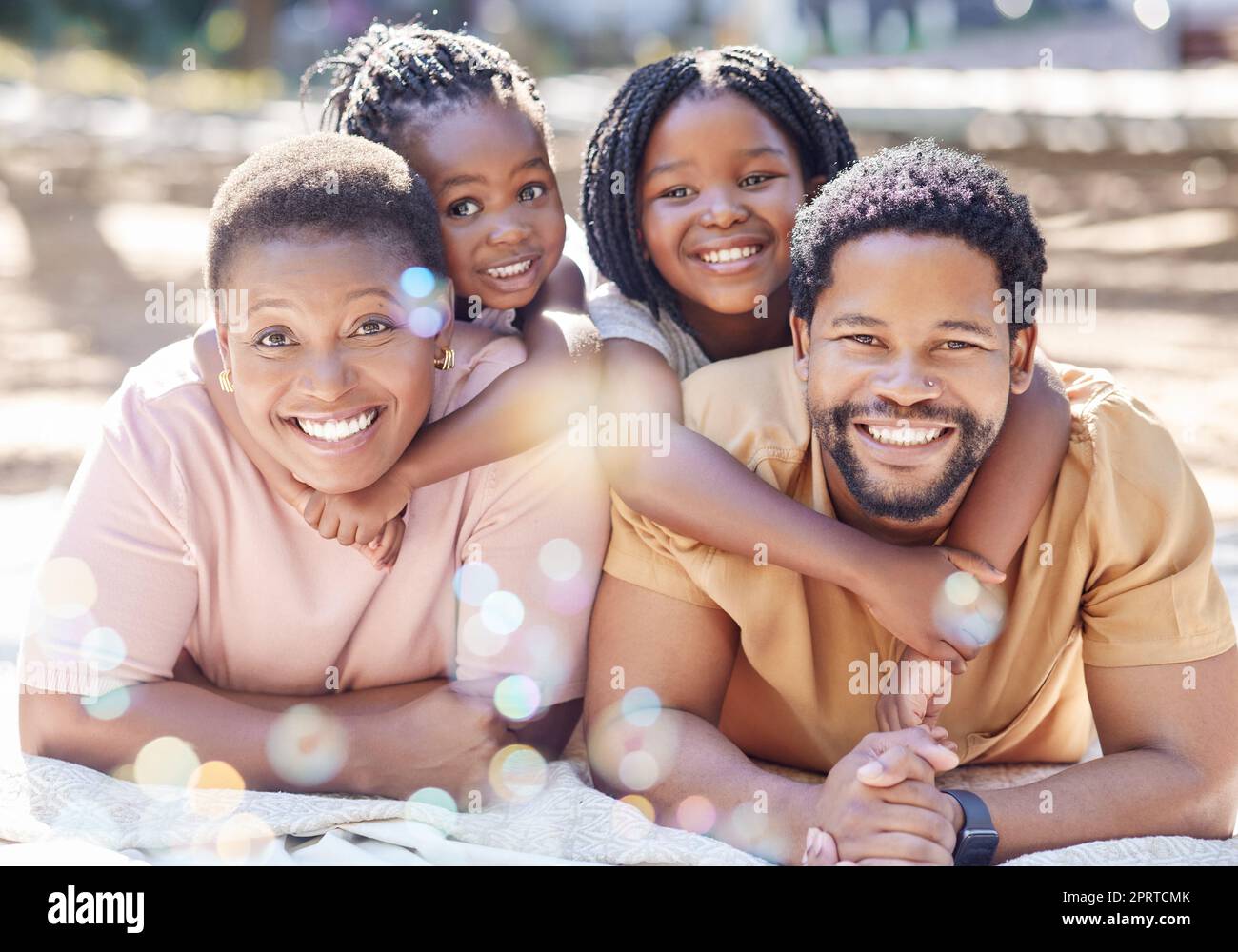 African family, happy portrait and park in summer, children in nature with parents and happy in garden during summer vacation. Face of girl kids with smile for mother and dad on holiday in spring Stock Photo