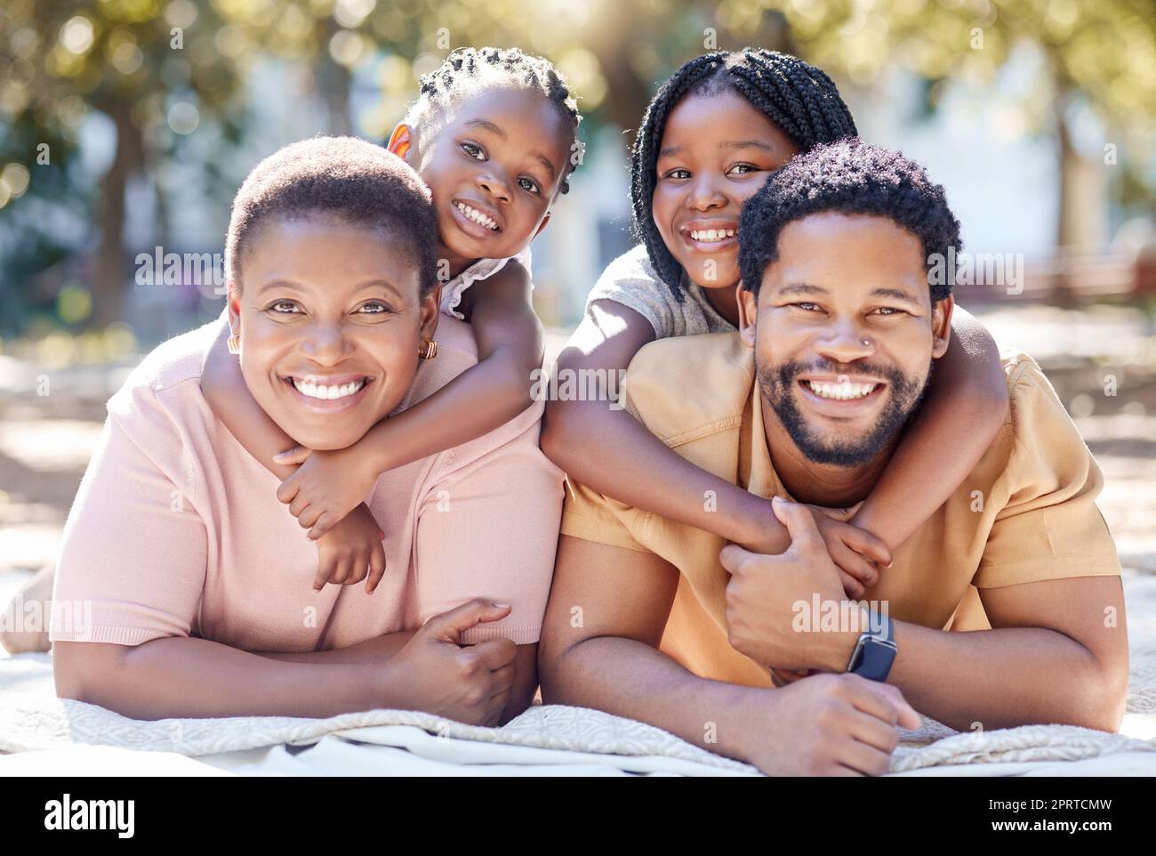 Portrait of relax black family in picnic nature park enjoy quality time, outdoor peace or freedom while bonding together. Love, hug and happy kids or children smile on spring holiday with mom and dad Stock Photo