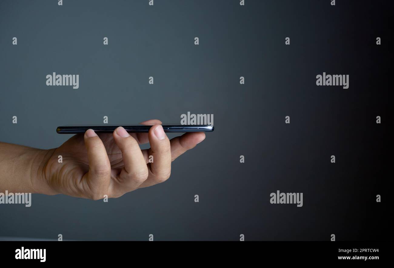 The phone is placed on the lid of the person's hand. Communication technology concept. Stock Photo