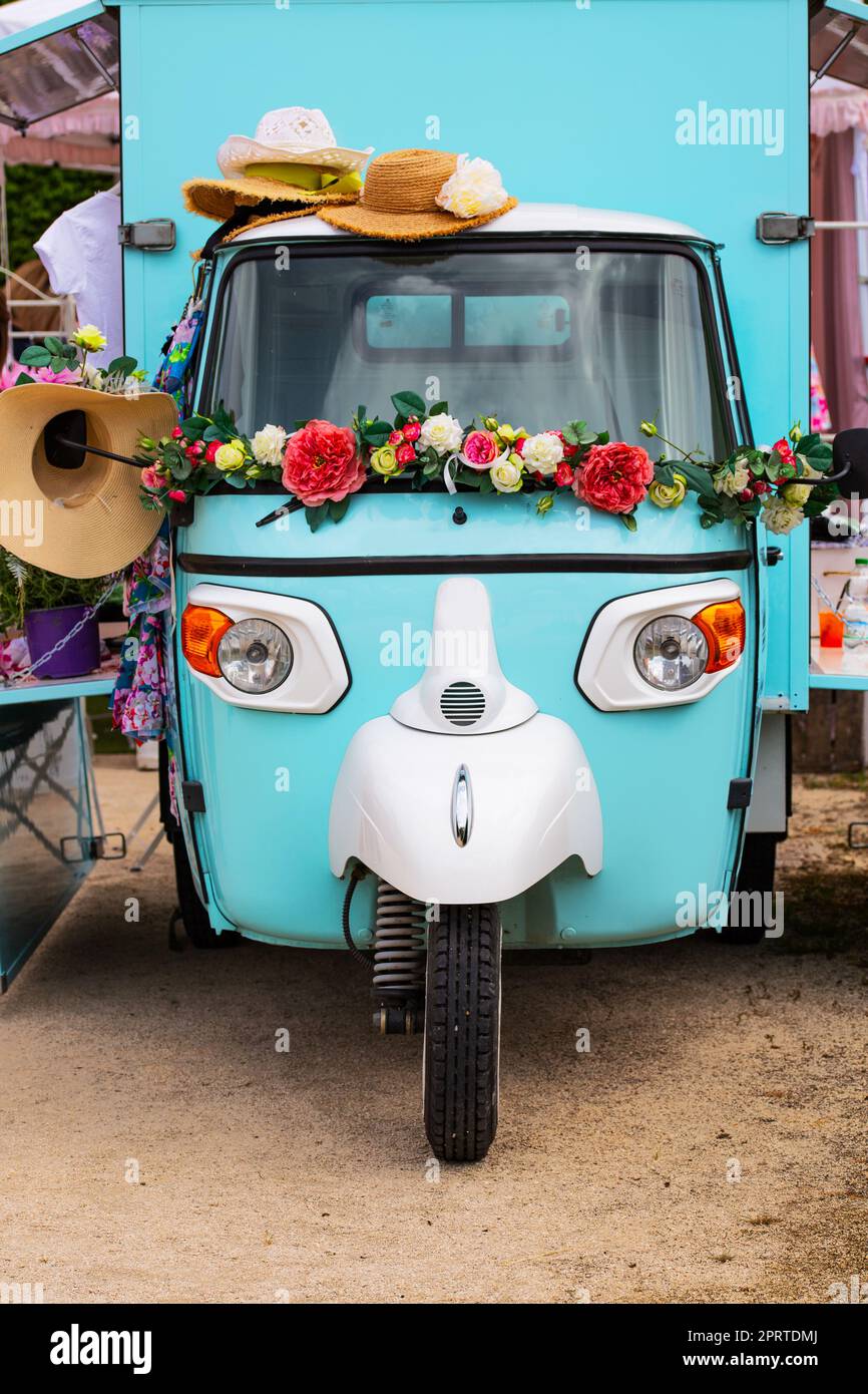 old motorized alley of the Italian tradition decorated with flowers Stock Photo