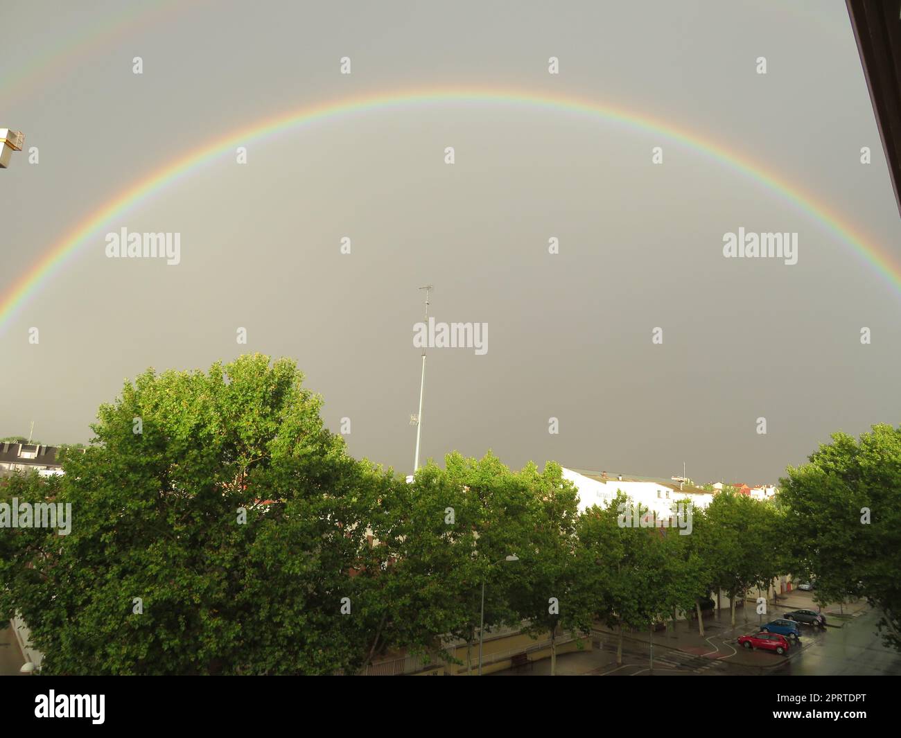 beautiful rainbow colors rain immense sky large red blue yellow Stock Photo