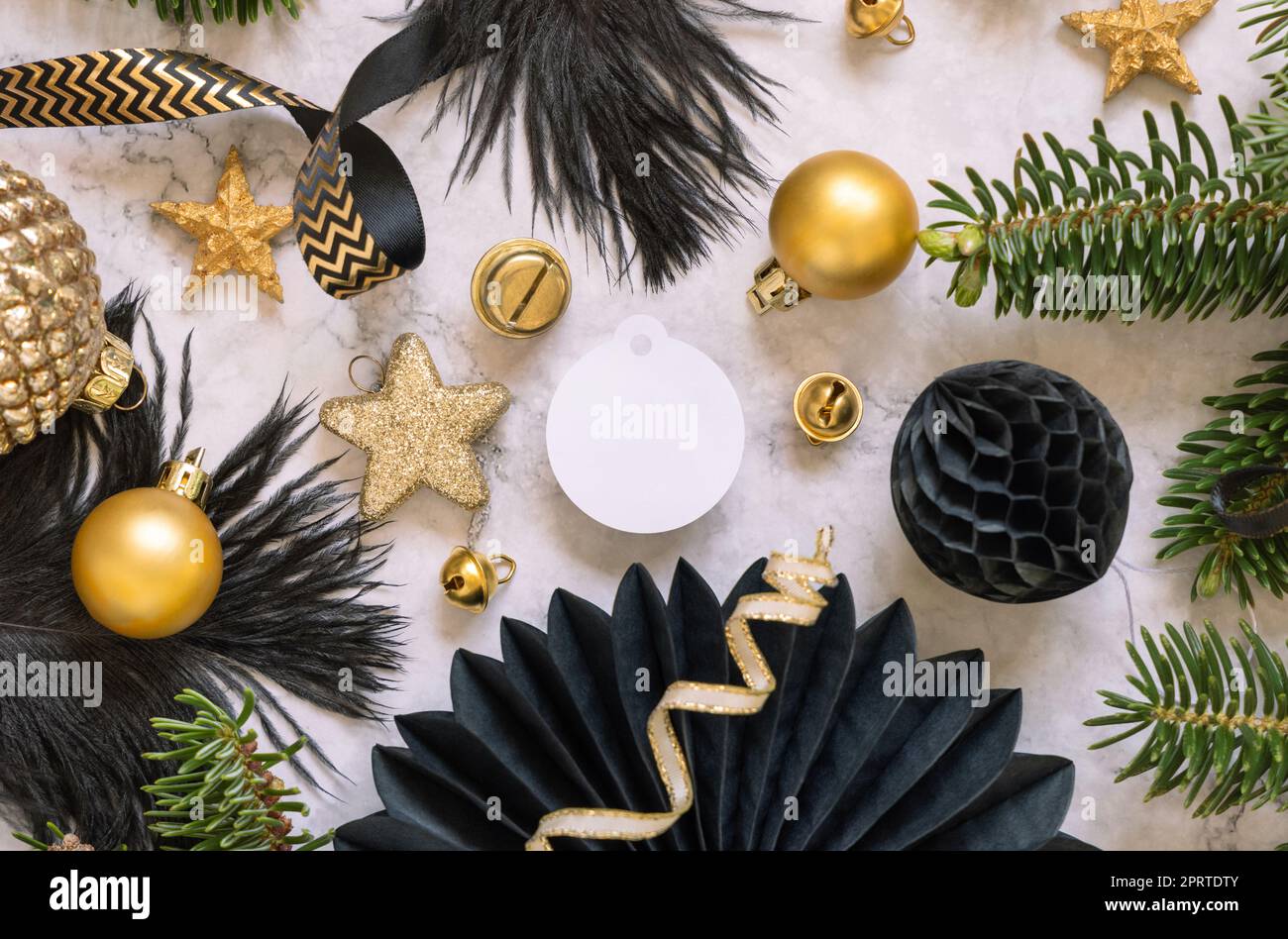 Blank round gift tag between black and golden Christmas decorations ...