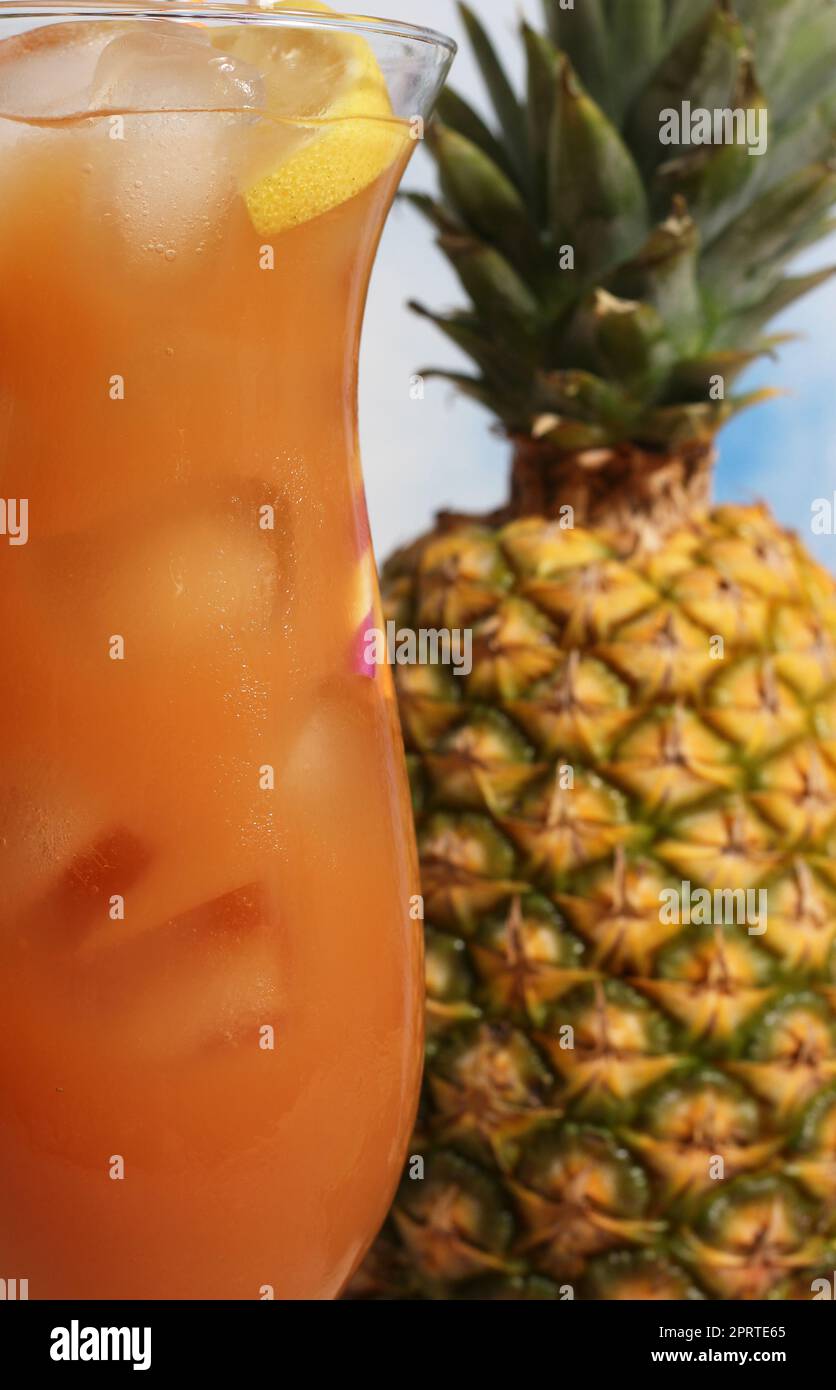 Tropical Hurricane Drink on Beach With Orange and Pineapple Fresh Cocktail With Juice Stock