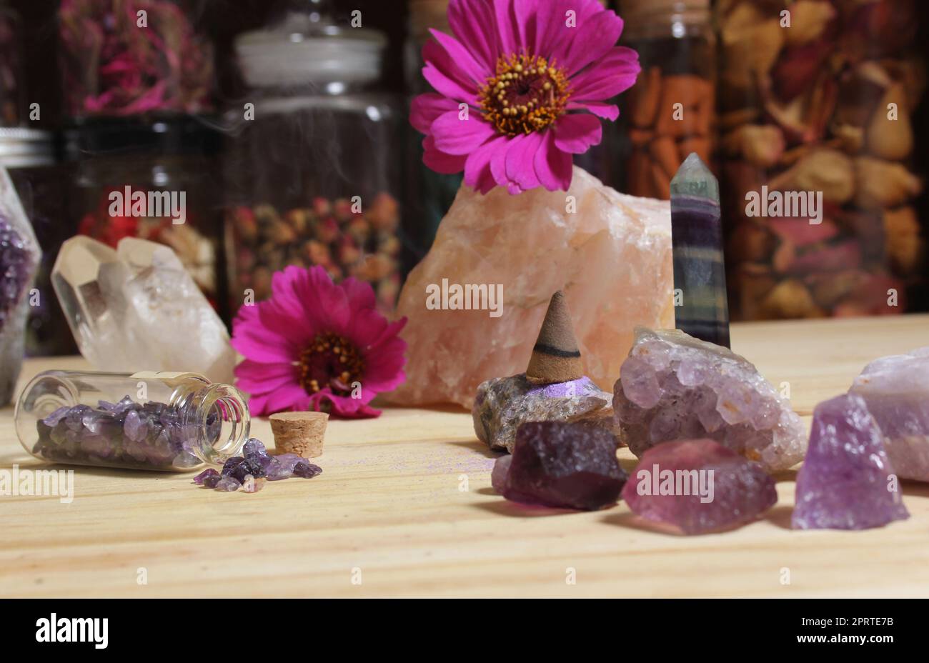 Amethyst Crystals With Flowers and Incense Cone on Meditation Table Stock Photo