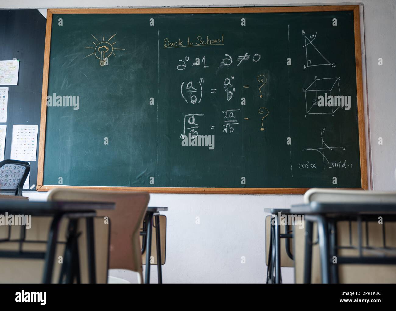 Empty classroom with chairs elementary school desks and chalkboard Stock Photo