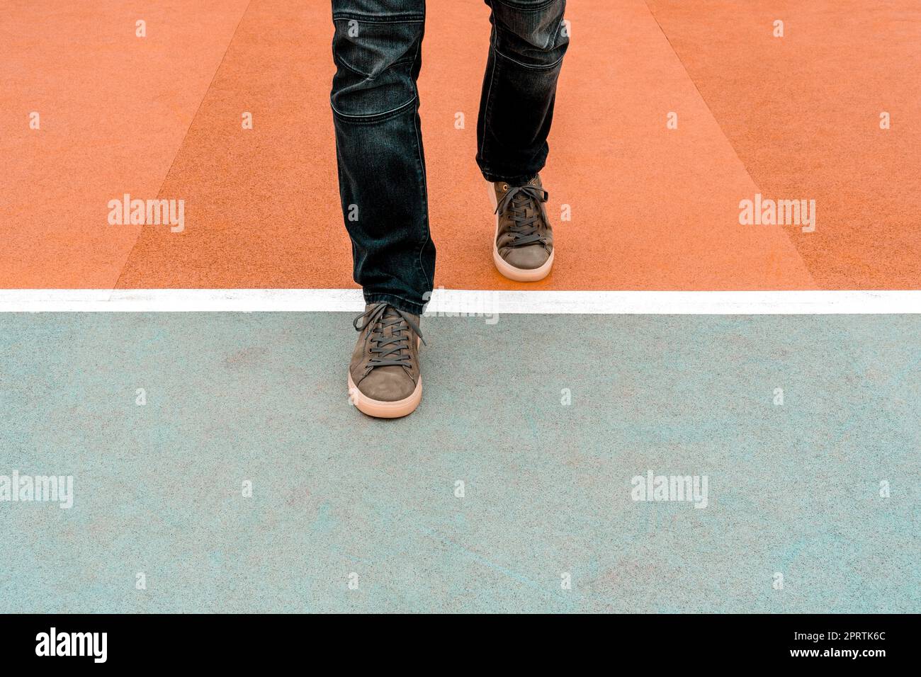 Man stepping over a white line Stock Photo - Alamy