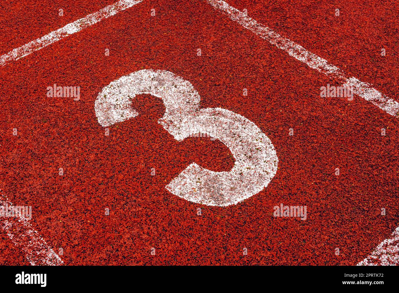 The number 3 at start point of running track Stock Photo