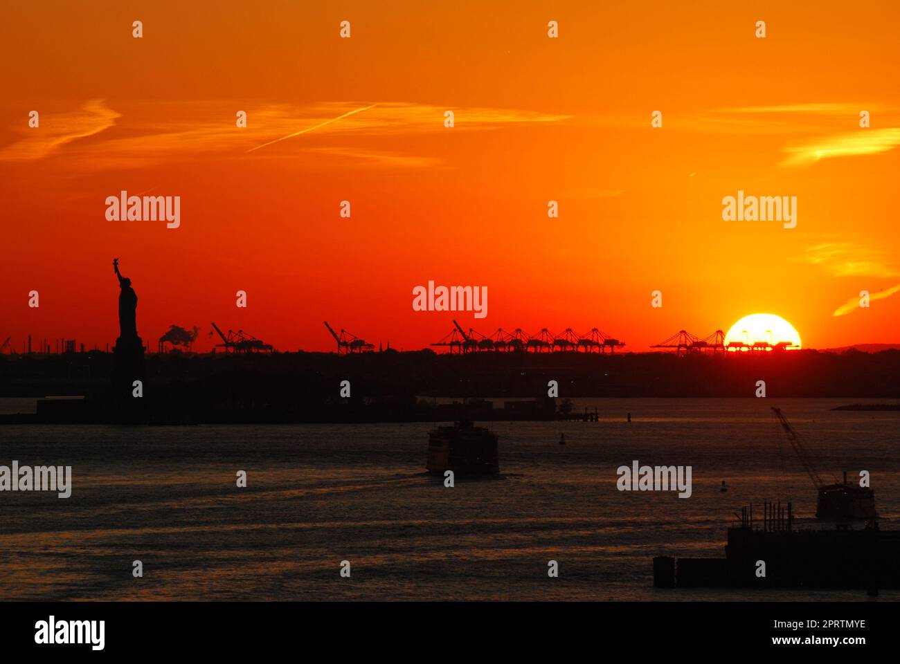 Silhouette of Statue of Liberty and Liberty Island in New York against ...