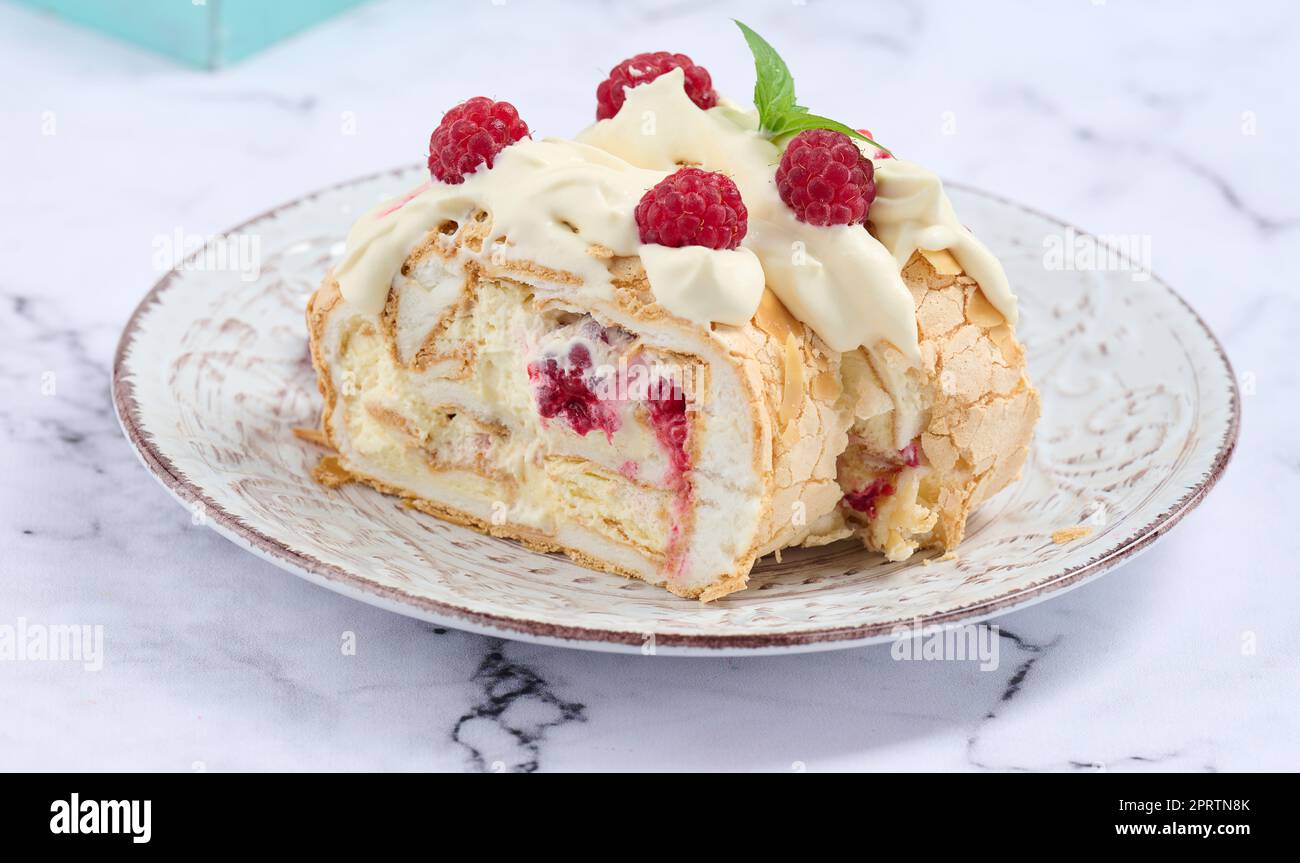 Baked meringue roll with cream and fresh red raspberry, white ...