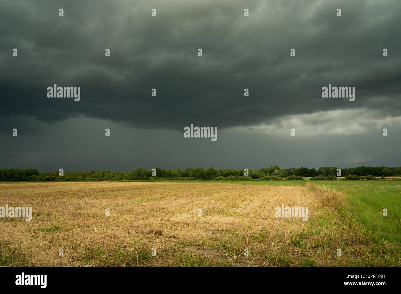 A dark stormy cloud over the fields Stock Photo - Alamy