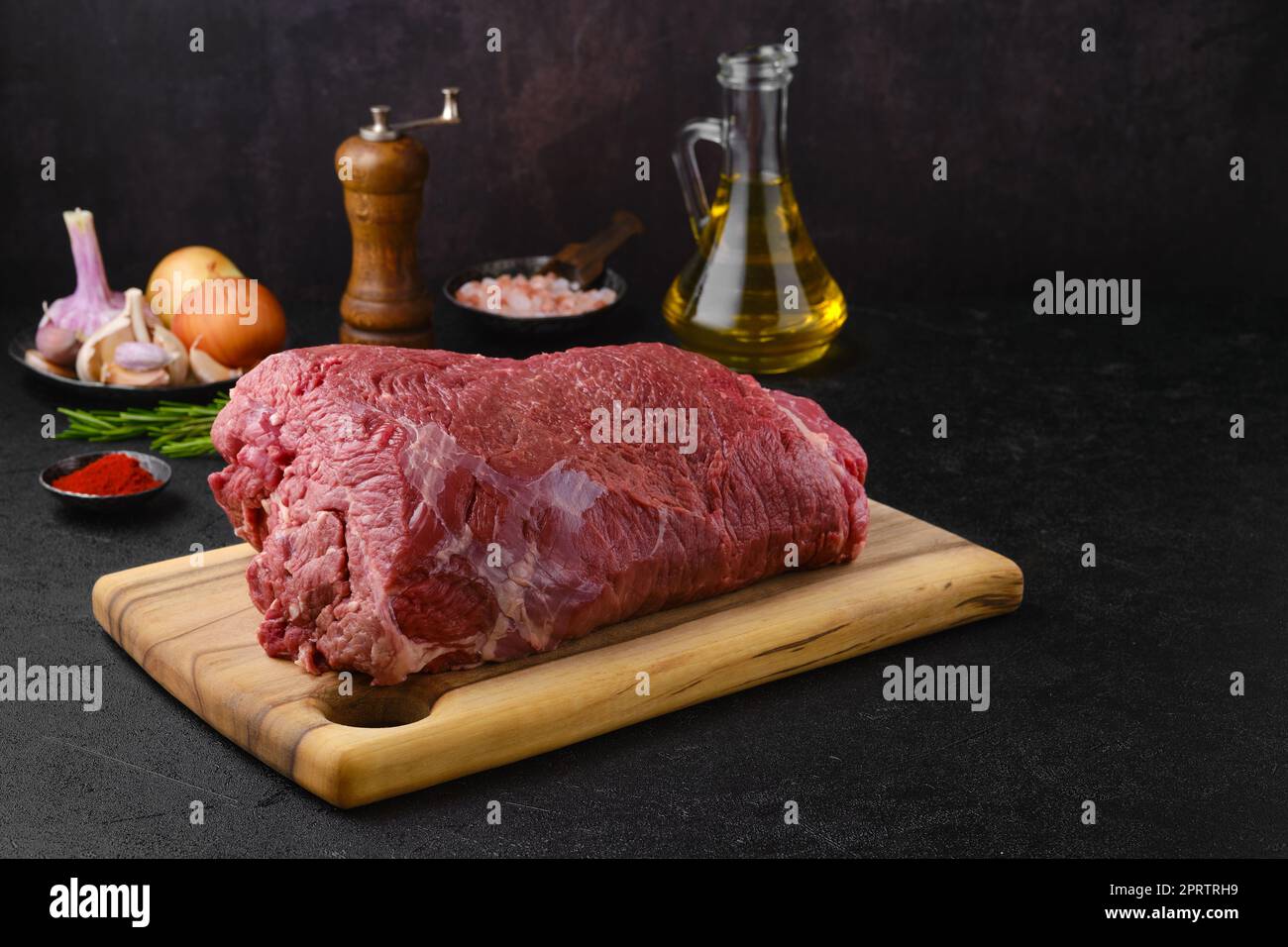 Overhead view of raw chuck eye roast with ingredients ready for cooking