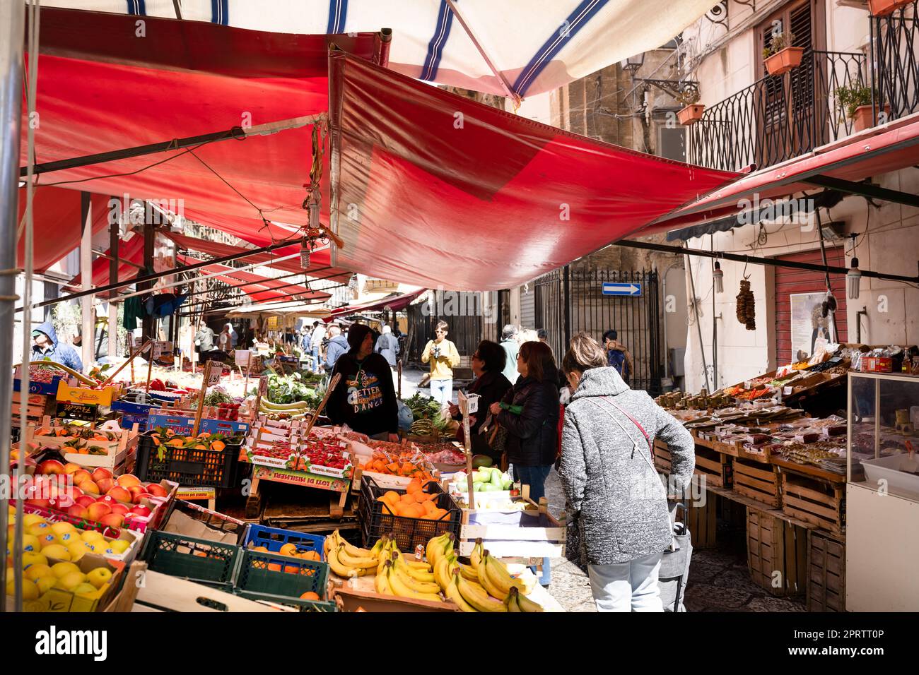 A market in a historic street in Palermo with many covered market